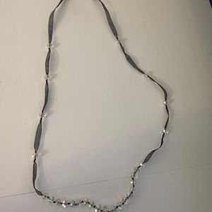 Boutique black necklace with clear beads on it